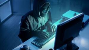 hacker on computer in the dark