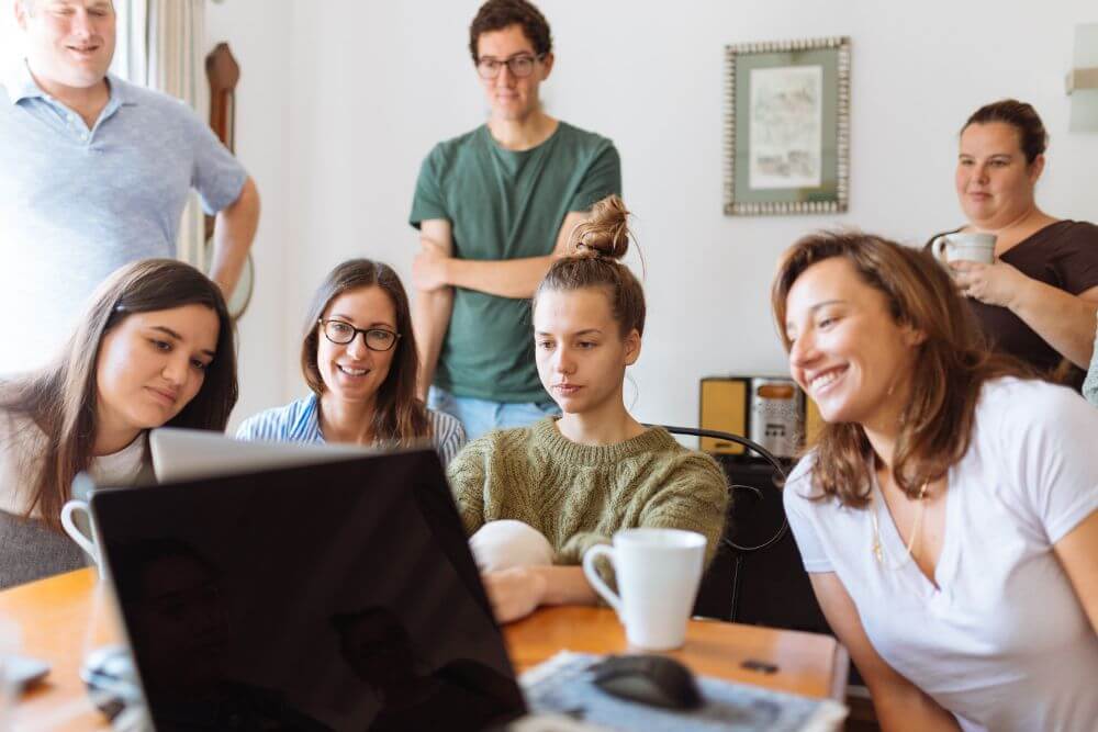 People looking at laptop working at office business VPN